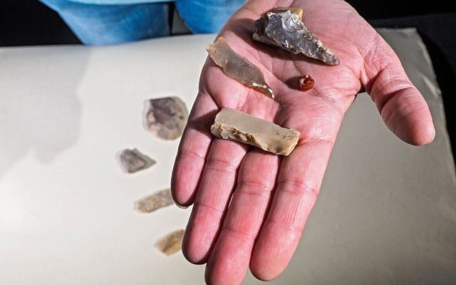 Polished flint ax and blades, and a gemstone bead dating back 7,000 years, found during archaeological excavations in the Shuafat neighborhood, northern Jerusalem. (Assaf Peretz/Israel Antiquities Authority)