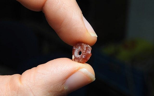 A 7,000-year-old bead found during archaeological excavations in the Shuafat neighborhood, northern Jerusalem. (Ronit Lupo/Israel Antiquities Authority)