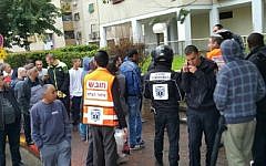 Paramedics and onlookers at the scene of a stabbing in the central Israeli town of Ramle on February 8, 2016. (Hatzolah)