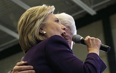 Hillary Clinton, accompanied by her husband, former President Bill Clinton, turns to address the crowd he introduced her at a campaign event in Nashua, New Hampshire, February 2, 2016. (AP Photo/Elise Amendola)