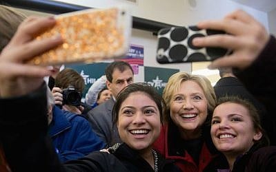 Democratic presidential candidate Hillary Clinton takes photos with workers at her campaign office in Des Moines, Iowa, Monday, Feb. 1, 2016. (AP Photo/Andrew Harnik)