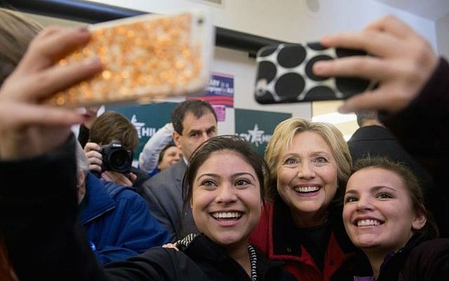 Democratic presidential candidate Hillary Clinton takes photos with workers at her campaign office in Des Moines, Iowa, Monday, Feb. 1, 2016. (AP Photo/Andrew Harnik)