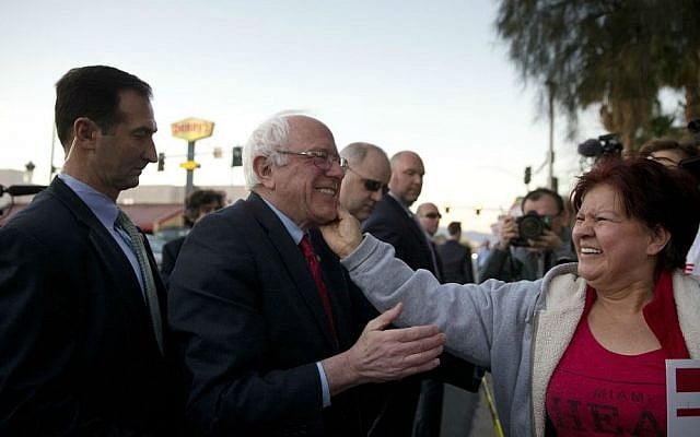 Democratic presidential candidate Sen. Bernie Sanders, I-Vermont, center, is greeted by a culinary worker protesting outside Sunrise Hospital in Las Vegas Thursday, Feb. 18, 2016. (AP Photo/Jae C. Hong)