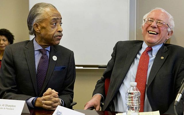 The Rev. Al Sharpton, President of the National Action Network, jokes with Democratic presidential candidate Sen. Bernie Sanders, I-Vermont, as the candidate meets with leaders of nine historic civil rights groups at the National Urban League Washington Bureau in Washington, Thursday, Feb. 18, 2016. (AP Photo/Jacquelyn Martin)