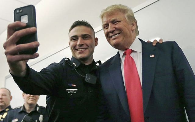 Patrolman James Pittman poses for a selfie with Republican presidential candidate Donald Trump during a campaign stop at police headquarters in Manchester, N.H., Thursday, Feb. 4, 2016. (AP Photo/Charles Krupa) Patrolman James Pittman poses for a selfie with Republican presidential candidate Donald Trump during a campaign stop at police headquarters in Manchester, N.H., Thursday, Feb. 4, 2016. (AP Photo/Charles Krupa)