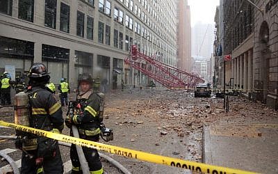 A collapsed crane lies on the street on Friday, Feb. 5, 2016, in New York. (AP Photo/Bebeto Matthews)