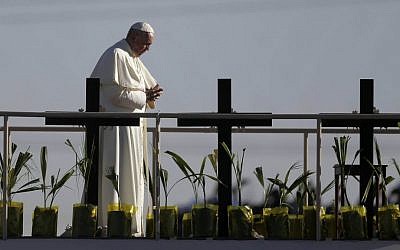 Pope Francis stands on a platform near the US-Mexico border fence along the Rio Grande, in Ciudad Juarez, Mexico, Wednesday, Feb. 17, 2016, as seen from in El Paso, Texas. (AP Photo/Eric Gay)