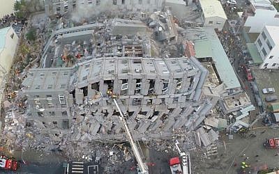 In this photo taken from a drone, rescue workers search a collapsed building from an early morning earthquake in Tainan, Taiwan, Saturday, Feb. 6, 2016. (AP Photo)