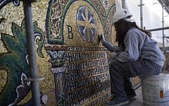 A restoration expert works on a mosaic inside the Church of the Nativity in the West Bank city of Bethlehem on Feb 4, 2016. (AP Photo/Nasser Nasser)
