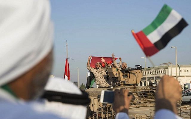 Emirati people wave the national flag as a convoy of UAE military vehicles and personnel travels from Al-Hamra Military Base to Zayed Military City on Nov. 7, 2015. (Ryan Carter-Crown Prince Court - Abu Dhabi/WAM via AP) Emirati people wave the national flag as a convoy of UAE military vehicles and personnel travels from Al-Hamra Military Base to Zayed Military City on Nov. 7, 2015. (Ryan Carter-Crown Prince Court - Abu Dhabi/WAM via AP)