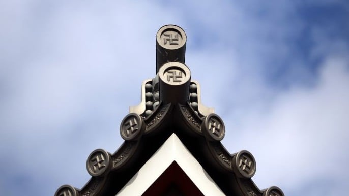 The roof of a temple in Tokyo marked with the "manji" symbol, the mirror image of a swastika, which comes from the ancient Sanskrit and has been widely used for centuries to denote Buddhist temples on maps and elsewhere, February 3, 2016 (AP Photo/Eugene Hoshiko) The roof of a temple in Tokyo marked with the "manji" symbol, the mirror image of a swastika, which comes from the ancient Sanskrit and has been widely used for centuries to denote Buddhist temples on maps and elsewhere, February 3, 2016 (AP Photo/Eugene Hoshiko)