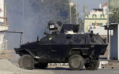 File: A police armored vehicle splattered with paint bombs fires tear gas toward Bahraini anti-government protesters during clashes in Sitra, Bahrain, on Sunday, February 14, 2016. (Hasan Jamali/AP)