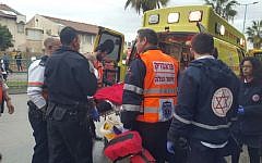A boy being loaded in an ambulance after being stabbed in Ramle on February 8, 2016. (Ichud Hatzala)