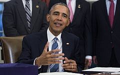 US President Barack Obama, with lawmakers and supporters of the bill, signs H.R. 644, the Trade Facilitation and Enforcement Act of 2015 during a ceremony in the Oval Office of the White House on February 24, 2016 in Washington, DC. (Shawn Thew-Pool/Getty Images via JTA)