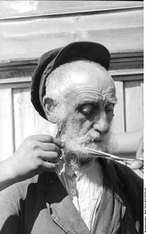 German soldiers cut the beard of an old Jewish man in July 1941 (CC BY-SA Friedrich Gehrmann/Wikimedia Commons)