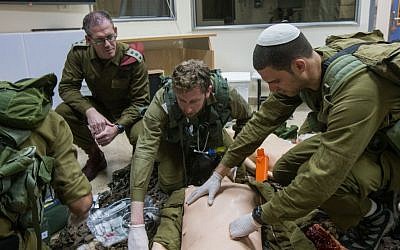 Col. Dr. Hagai Frankel (center, red beret) watches as a tem of IDF medical personnel treat their 'patients,' smart dolls that mimics the human respiratory and circulatory systems, in the Medical Simulation Center at Tel Hashomer Hospital in Ramat Gan on February 11, 2016. (Adi Brown/IDF Spokesperson's Unit) Col. Dr. Hagay Frenkel (center, red beret) watches as a team of IDF medical personnel treat their 'patients,' smart dolls that mimics the human respiratory and circulatory systems, in the Medical Simulation Center at Tel Hashomer Hospital in Ramat Gan on February 11, 2016. (Adi Brown/IDF Spokesperson's Unit)