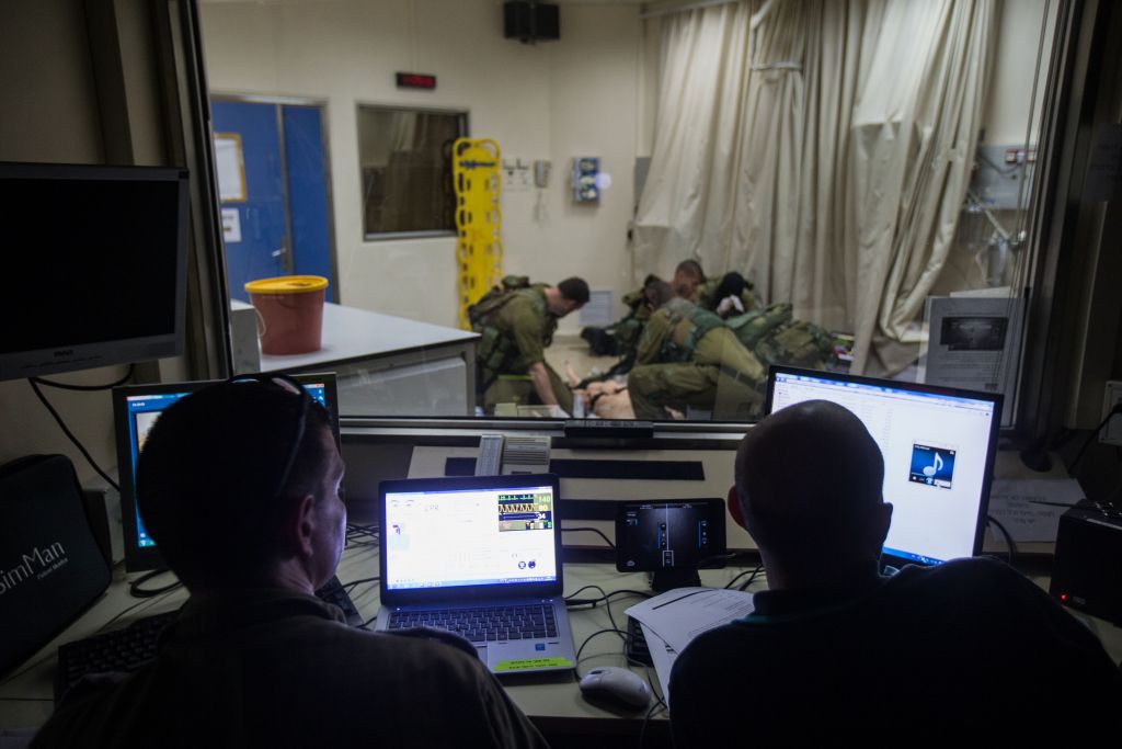 Operators watch from a control room as IDF medical personnel treat their 'patients,' smart dolls that mimics the human respiratory and circulatory systems, in the Medical Simulation Center at Tel Hashomer Hospital in Ramat Gan on February 11, 2016. (Adi Brown/IDF Spokesperson's Unit) Operators watch from a control room as IDF medical personnel treat their 'patients,' smart dolls that mimics the human respiratory and circulatory systems, in the Medical Simulation Center at Tel Hashomer Hospital in Ramat Gan on February 11, 2016. (Adi Brown/IDF Spokesperson's Unit)