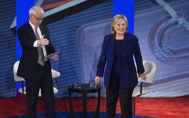 Democratic presidential candidate Hillary Clinton, right, stands to answer a question from the audience alongside host Anderson Cooper during a Democratic primary town hall sponsored by CNN, Wednesday, February 3, 2016, in Derry, N.H. (AP/John Minchillo)