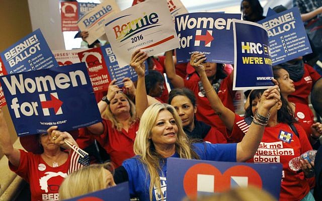 Supporters of Hillary Clinton and Bernie Sanders cheer on their presidential candidates before entering a caucus site during the Nevada Democratic caucus, Saturday, Feb. 20, 2016, in Las Vegas. (AP Photo/John Locher)