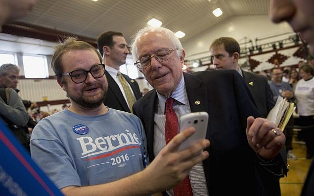 Democratic presidential candidate, Sen. Bernie Sanders, I-Vt. pauses for a photo with a supporter at a rally, Friday, Feb. 19, 2016, in Elko, Nev. (AP Photo/Jae C. Hong)