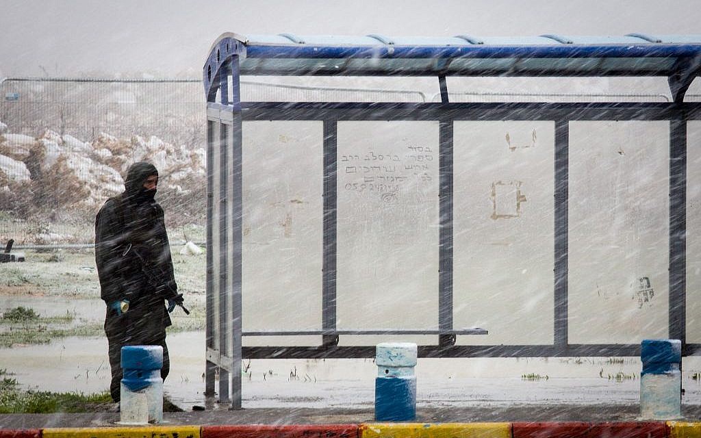 An IDF soldier guards at a bus stop in Gush Etzion, south of Jerusalem, on January 25, 2016. (Nati Shohat/Flash90) An IDF soldier guards at a bus stop in Gush Etzion, south of Jerusalem, on January 25, 2016. (Nati Shohat/Flash90)