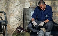 Police investigator near the bodies of Palestinian attackers at the scene of a shooting and stabbing attack near Damascus Gate, Jerusalem, February 3, 2016. (Yonatan Sindel/Flash90)