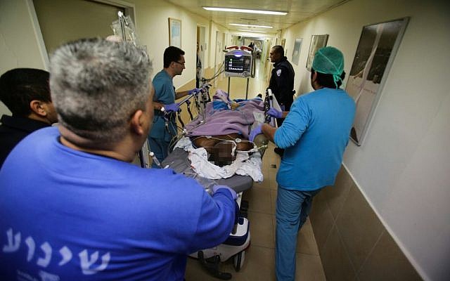 Medical personnel rush a suspected stabber into the emergency unit at Barzilai Hospital in Ashkelon on February 7, 2016. (Edi Israel/Flash90)