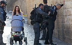 Illustrative: Israeli police officers frisk a Palestinian young man at Damascus Gate in Jerusalem Old City on February 15, 2016. (Nati Shohat/Flash90)