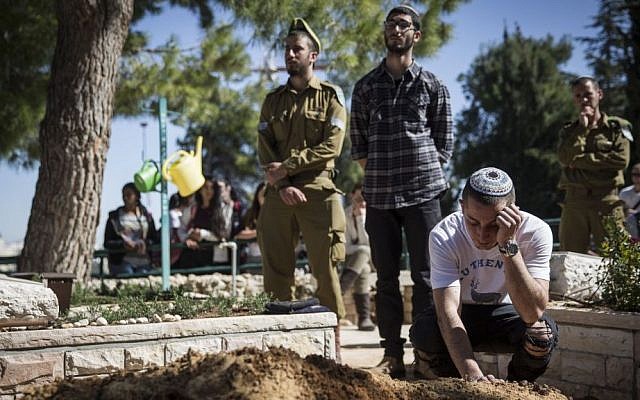 Friends seen mourning after the funeral of Tuvia Yanai Weissman, at the Mount Herzl military cemetery in Jerusalem, on February 18, 2016. (Hadas Parush/Flash90) Friends seen mourning after the funeral of Tuvia Yanai Weissman, at the Mount Herzl military cemetery in Jerusalem, on February 18, 2016. (Hadas Parush/Flash90)