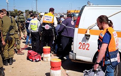 Security forces and rescue personnel at the scene of a terror attack at Gush Etzion Junction, on February 24, 2016. (Gershon Elinson/FLASH90)