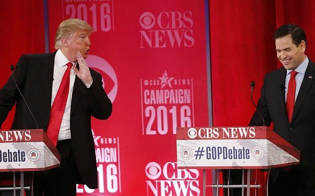 Republican presidential candidate businessman Donald Trump speaks to Republican presidential candidate Sen. Marco Rubio, R-Florida, during the CBS News Republican presidential debate at the Peace Center, Saturday, Feb. 13, 2016, in Greenville, South Carolina. (AP Photo/John Bazemore)