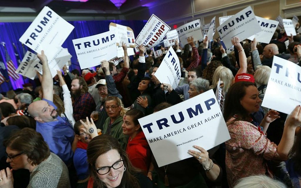Supporters for Republican presidential candidate Donald Trump hold signs during a South Carolina Republican primary night event Saturday, Feb. 20, 2016, in Spartanburg, South Carolina. (AP Photo/Paul Sancya)