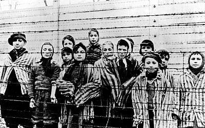This photo, taken just after the liberation by the Soviet army in January, 1945, shows a group of children behind barbed wire fencing in the Oswiecim (Auschwitz) Nazi concentration camp. (AP Photo)