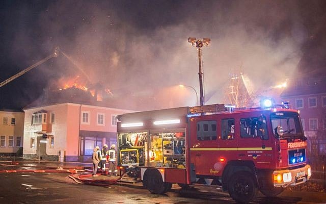 A fire engine stands in front of a burning building in Bautzen, eastern Germany, Sunday, February 21, 2016. (Rico Loeb/dpa via AP) A fire engine stands in front of a burning building in Bautzen, eastern Germany, Sunday, February 21, 2016. (Rico Loeb/dpa via AP)