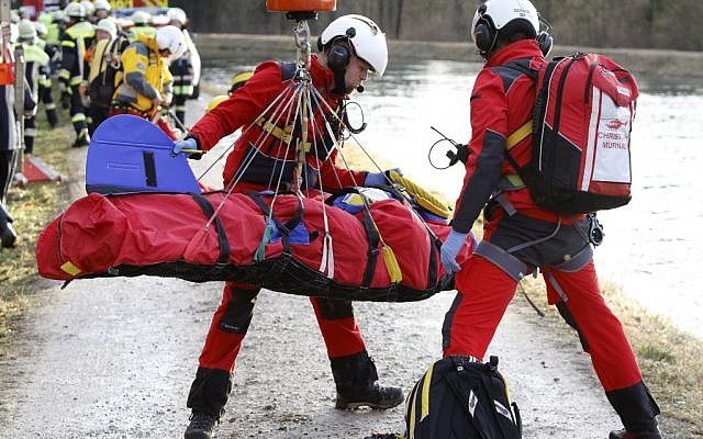 Rescue teams salvage an injured person at the site of a train accident near Bad Aibling, Germany, Tuesday, Feb. 9, 2016 (Uwe Lein/dpa via AP)