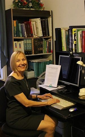 Ruth Kohn at work on her computer in her home office full of dictionaries. (Lior Elgavi)