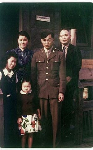 In this 1945 photo provided by Alice Tanaka Hikido, members of the Tanaka family stand together at the Minidoka Japanese internment camp in Jerome, Idaho, where they were held in forced incarceration during World War II. (Alice Tanaka Hikido via AP) 