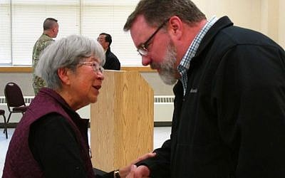 In this Friday, Feb. 19, 2016 photo at Joint Base Elmendorf-Richardson, Alaska, Alice Tanaka Hikido, left, speaks with base spokesman Jim Hart. (AP Photo/Rachel D'Oro) 