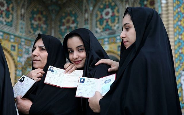 Iranian women show their identification, as they queue in a polling station to vote for the parliamentary and Experts Assembly elections in Qom, 125 kilometers (78 miles) south of the capital Tehran, Iran, Friday, Feb. 26, 2016. (AP Photo/Ebrahim Noroozi) Iranian women show their identification, as they queue in a polling station to vote for the parliamentary and Experts Assembly elections in Qom, 125 kilometers (78 miles) south of the capital Tehran, Iran, Friday, Feb. 26, 2016. (AP Photo/Ebrahim Noroozi)