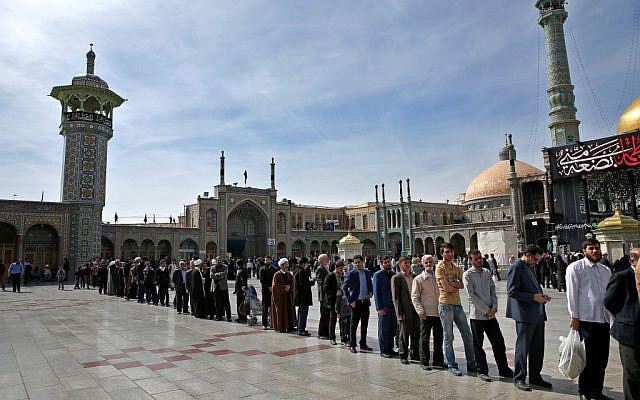 Iranians stand in line at a polling station during the parliamentary and Experts Assembly elections in Qom, 125 kilometers (78 miles) south of the capital Tehran, Iran, Friday, February 26, 2016. (AP Photo/Ebrahim Noroozi)
