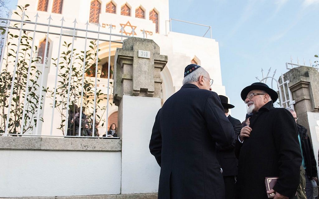 Illustrative: Turkish Chief Rabbi Ishak Haleva, right, talking to congregants outside Kadoorie – Mekor Haim synagogue in Porto, Portugal, January 29, 2016 (Cnaan Liphshiz/JTA)