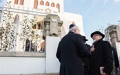 Illustrative: Turkish Chief Rabbi Ishak Haleva, right, talking to congregants outside Kadoorie – Mekor Haim synagogue in Porto, Portugal, January 29, 2016 (Cnaan Liphshiz/JTA)