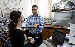 Professor Hossam Haick talks to a researcher in his lab at Technion University in Haifa, Israel, February 14, 2016. (AP Photo/Dusan Vranic)