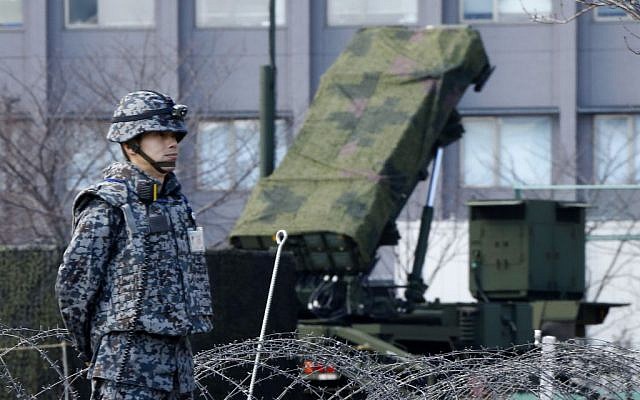 A Japan Self-Defense Force member stands by a PAC-3 Patriot missile unit deployed for North Korea's rocket launch at the Defense Ministry in Tokyo, Sunday, January 31, 2016. (AP Photo/Shizuo Kambayashi)