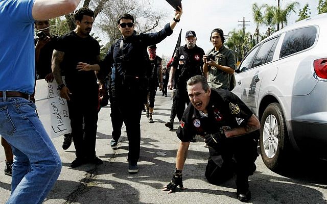 Counter protesters taunt an injured Ku Klux Klansman after members of the KKK tried to start a "White Lives Matter" rally at Pearson Park in Anaheim, California on Saturday, Feb. 27, 2016. (Luis Sinco/Los Angeles Times via AP)