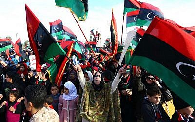 Libyans celebrate ahead of the fourth anniversary of the Libyan revolution which toppled dictator Muammar Gaddafi, on February 17, 2015. (MAHMUD TURKIA / AFP)