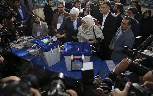 Head of the reformists' coalition list of the Iranian parliamentary elections in Tehran Mohammad Reza Aref, center, and his wife Hamideh Moravej Farshi cast their ballots at a polling station in northern Tehran, Iran, Friday, Feb. 26, 2016. (AP Photo/Vahid Salemi) Head of the reformists' coalition list of the Iranian parliamentary elections in Tehran Mohammad Reza Aref, center, and his wife Hamideh Moravej Farshi cast their ballots at a polling station in northern Tehran, Iran, Friday, Feb. 26, 2016. (AP Photo/Vahid Salemi)