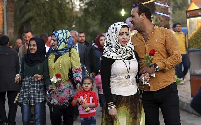 In this Saturday, Feb. 13, 2016 photo, Iraqis hold Valentine's Day gifts at Zawra Park in Baghdad, Iraq. Baghdad is plastered with Valentine hearts and roses, and Iraqis are enjoying a rare lull in violence but wondering how long it will last. (AP Photo/Hadi Mizban) In this Saturday, Feb. 13, 2016 photo, Iraqis hold Valentine's Day gifts at Zawra Park in Baghdad, Iraq. Baghdad is plastered with Valentine hearts and roses, and Iraqis are enjoying a rare lull in violence but wondering how long it will last. (AP Photo/Hadi Mizban)