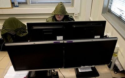 An Israeli soldier on the autism spectrum, whose face cannot be shown due to his classified position, works on a computer in a small office in downtown Tel Aviv on Feb. 9, 2016 (AP Photo/Sebastian Scheiner)