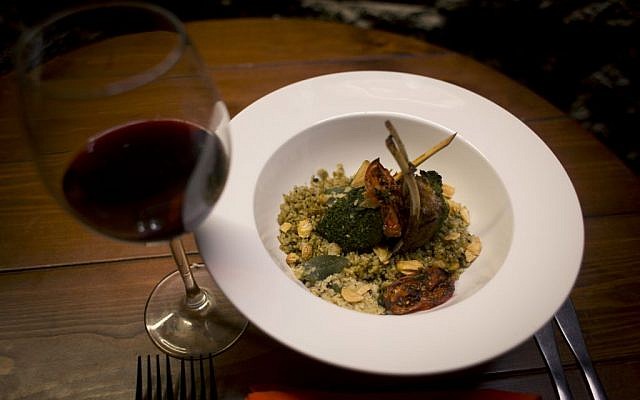 In this photo taken on Saturday Feb. 20, 2016, a mixed Palestinian French dish, Freekeh lamb rack, is seen at Orjuwan restaurant in the West Bank city of Ramallah. (AP Photo/Nasser Nasser)